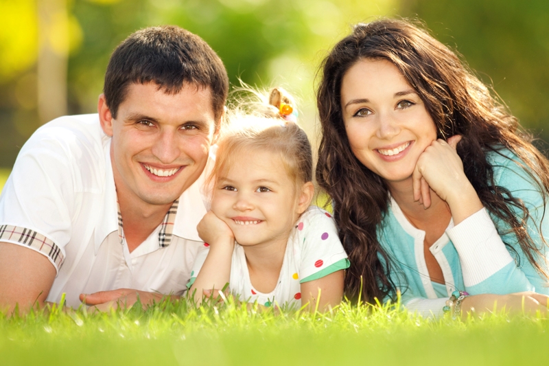 Happy mother, father and daughter in the park